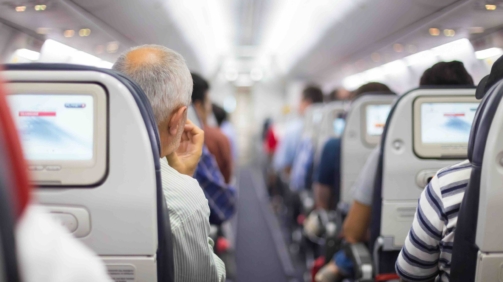 Interior of airplane with passengers on seats waiting to taik off.