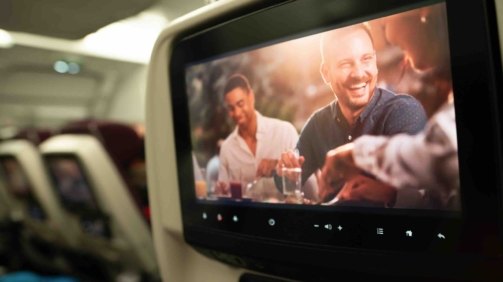 DOHA, QATAR - DECEMBER 15, 2023: a Qatar Airways economy class seat equipped with in-flight entertainment system.