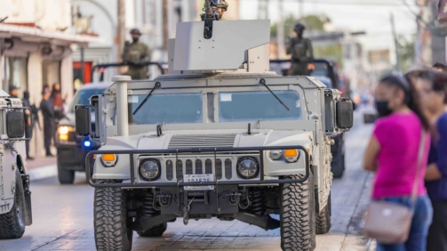 Matamoros, Tamaulipas, Mexico - September 16, 2022: Desfile 16 de Septiembre, Humvee of the Mexican navy with a soldier handling a heavy machine gun in it is turret